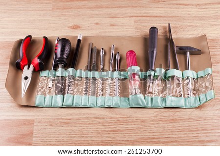 Set of various tools for repairs around the house on a background of wooden floor