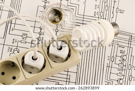 Different lamp with socket and plug on a background of drawings circuits