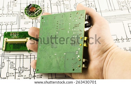 Chip green in hands on background drawings circuits