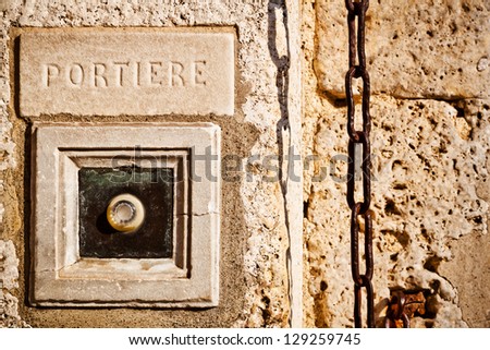RIng the doorbell for the concierge. A buzzer on an old stone palace.