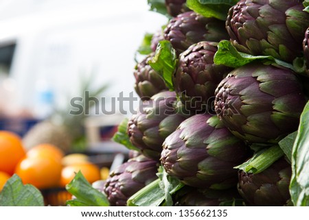 Artichokes for sale at farmers\' market. Fresh food and vegetables. Plenty of copy space in the blurred background. Selective focus.