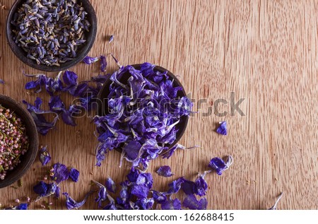 Dried flower petals: scented lavender, heather and larkspur. Copy space.