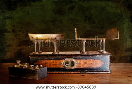Vintage kitchen scales with brass weights, against old worn out stone wall.