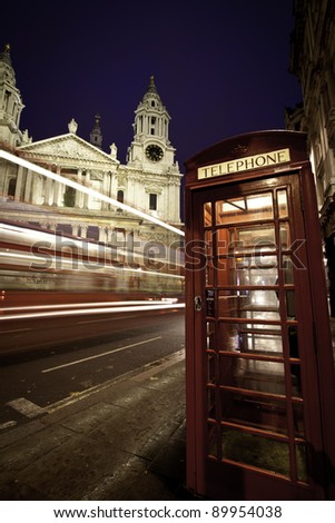 Traffic by St Paul\'s Cathedral at dusk, London. Blurred motion trail of bus passing by.