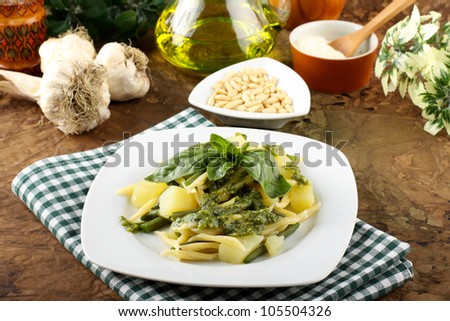 Pasta with pesto, green beans and potatoes on complex background