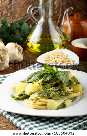 Pasta with pesto, potatoes and fagiolina on complex background