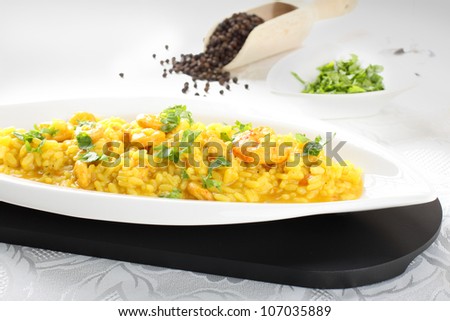Risotto with saffron and fresh shrimp on complex background