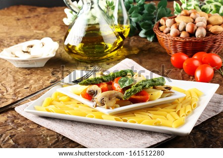 Pasta with fresh tuna, mushrooms and asparagus on complex background