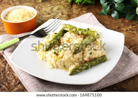 Rice with fresh asparagus on complex background