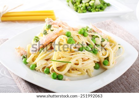 Pasta with salmon and peas on complex background
