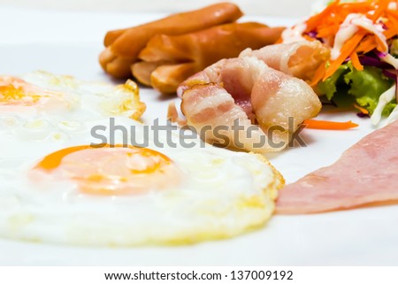 Breakfast eggs bacon and sausage with vegetable