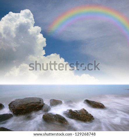 sea rock wave nature sand sun landscape blue sky and rainbow for wallpaper and design