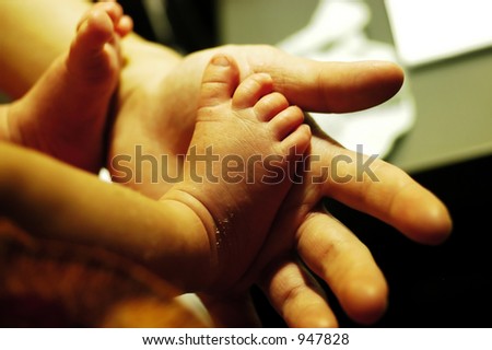 new born baby feet. intentional shallow Depth Of Field & warm ambient light.