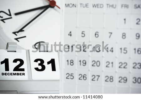 Mood shot of calendar with date and time background , focus on the flip date - intentional selective focus & vignetting.