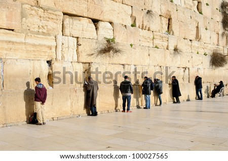 JERUSALEM - FEBRUARY 19: Jewish men pray at the western wall February 19, 2012 in Jerusalem, IL. The wall is one of the holiest sites in Judaism attracting thousands of worshipers daily.
