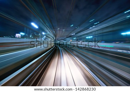 Motion Blur Of A City And Tunnel From Inside A Moving Monorail In Tokyo.