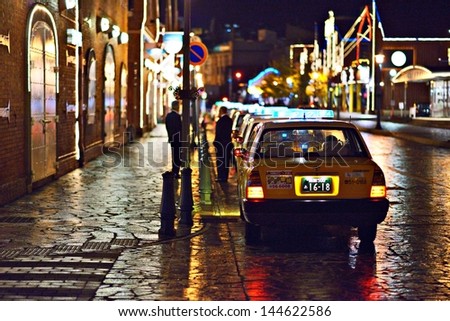 HAKODATE, JAPAN - OCTOBER 24: Taxis at warehouses on October 24, 2012 in Hakodate, JP. The city opened in 1859 as one of the first trading ports of Japan and the warehouses remain from that time.