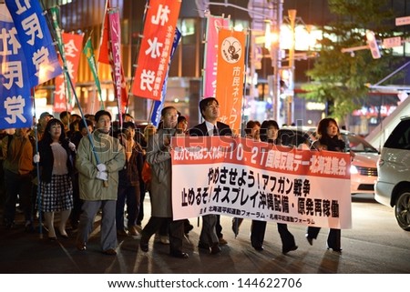 SAPPORO - OCTOBER 19: Protesters march against the Afghan War, deployment of Osprey aircraft in Okinawa, and nuclear energy usage October 19, 2012 in Sapporo, JP.