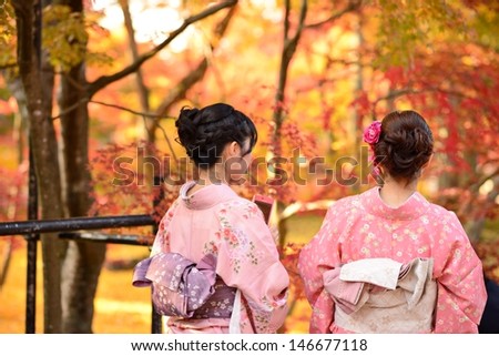 KYOTO - NOVEMBER 19: Women in traditional attire view fall foliage at Eikando Temple November 19, 2012 in Kyoto, JP. Viewing the fall foliage is a cultural pastime in Japan dating from antiquity.