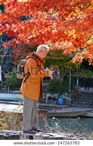 KYOTO - NOVEMBER 21: Tourists view fall foliage November 21, 2012 in Kyoto, JP. Viewing the fall foliage is a cultural pastime in Japan dating from antiquity.