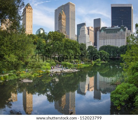 NEW YORK CITY - AUGUST 23: People enjoy central park under the skyline along Central Park South August 23, 2013 in New York, NY. The park opened in the 1860\'s to much fanfare.