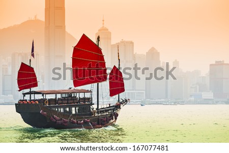Junk Ship Sails In Victoria Harbor In Hong Kong, China.
