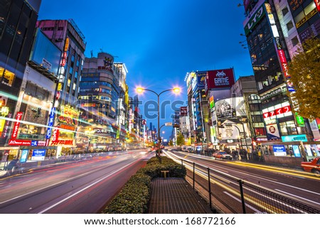 Tokyo, Japan - December 15, 2012: Traffic Passes Below Billboards In Shinjuku. The Area Is A Famed Nightlife District.