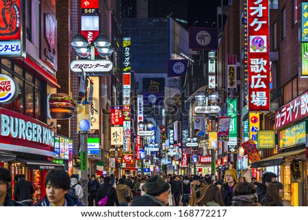 Tokyo, Japan - December 24, 2012: Crowds Walk Through Shibuya. The District Is A Youth And Fashion Center.