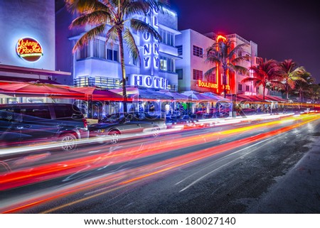 MIAMI, FLORIDA - JANUARY 6, 2014: Cars speed down Ocean Drive. The road is the main thoroughfare through South Beach.