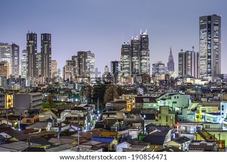 Tokyo, Japan office buildings in Shinjuku tower over residential homes in the Minami-dai neighborhood.