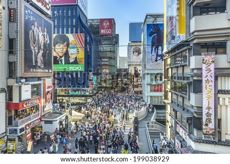 OSAKA, JAPAN - MAY 3, 2014: Crowds pass through the Dotonbori District during the Golden Week holiday. The district is a major entertainment area of the city.