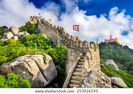 Sintra, Portugal at Castle of the Moors wall with Pena National Palace in the distance.