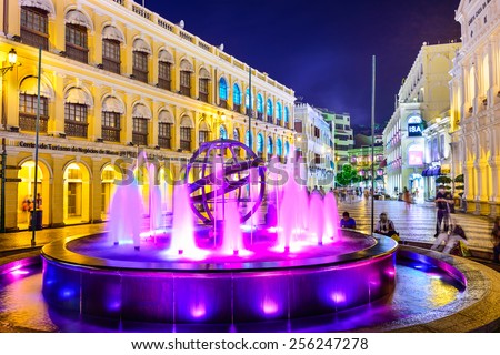 MACAU, CHINA - MAY 21, 2014: People enjoy Senado Square. The territory was the last European colony in Asia and the architecture is inspired by the former Portuguese rule.