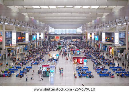 SHANGHAI, CHINA - JUNE 23, 2014: Passengers wait for trains in Shanghai Hongqiao Railway Station. It is the largest railway station in Asia with an area of 1.3 million square meters.