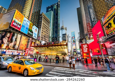 NEW YORK CITY - APRIL 9, 2013: Times Square crowds and traffic at dusk.The site is regarded as one of the world\'s most visited tourist attraction.
