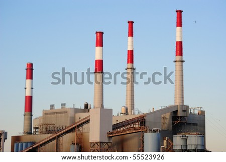 An industrial factory with smoke stacks.