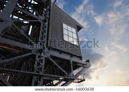 Industrial Gantry Control Room under dramatic sky lighting.