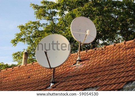 Satellite dishes on a tiled roof