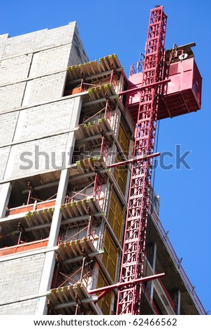 A building under construction with an elevator lift.