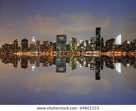 The midtown Manhattan Skyline across from the UN with serious reflections in New York City.