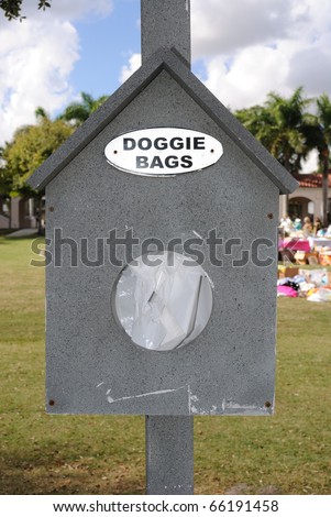 Bags in a dispenser intended for dog owners to pick up their pet\'s waste in a park.