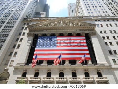 NEW YORK CITY - JUNE 4: The historic New York Stock Exchange on Wall Street with crowds below, one of the largest stock exchanges in the world June 4, 2010 in New York, New York.