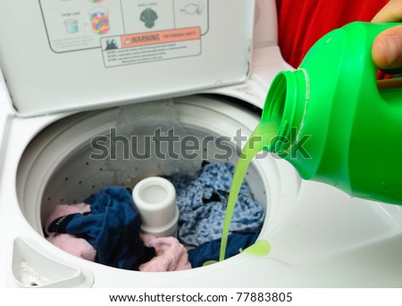 Pouring Detergent into the wash machine.