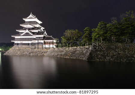 The historic Matsumoto Castle under pink skies, dating from the 15th Century in Matsumoto, Japan.