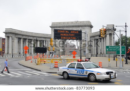 NEW YORK CITY - AUGUST 27: Traffic sign at Manhattan Bridge reporting evacuations during Hurricane Irene as Police drive by on August 27, 2011 in New York, NY.