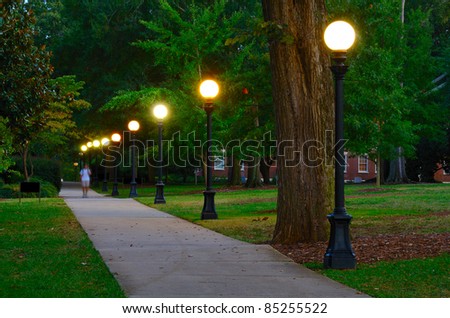 Historic college campus at dusk with lamp posts