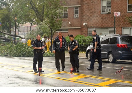 NEW YORK CITY - AUGUST 28: Police lay road flares to block a street with fallen trees and damage from Hurricane Irene August 28, 2011 in New York, NY.