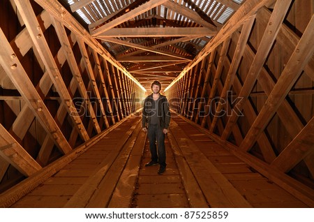 Urban explorer in an unused covered bridge