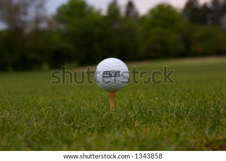 Golf Ball with \'Practice\' on it on a golf tee