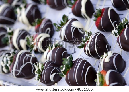 Chocolate covered strawberries with white chocolate drizzled on them